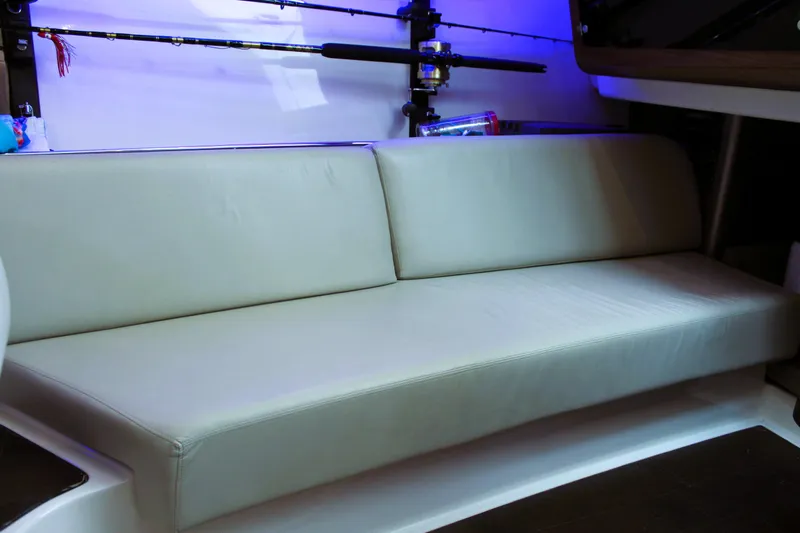 F-troop Yacht Photos Pics 2017 Boston Whaler 345 Conquest interior with cushioned seating and fishing rod holder.