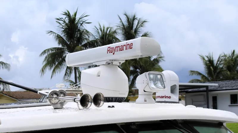 F-troop Yacht Photos Pics Radar and spotlight on 2017 Boston Whaler 345 Conquest boat, with palm trees in background.