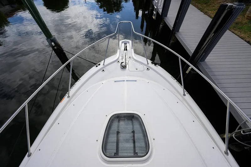 F-troop Yacht Photos Pics Bow view of 2017 Boston Whaler 345 Conquest docked, showcasing sleek design and water reflection.