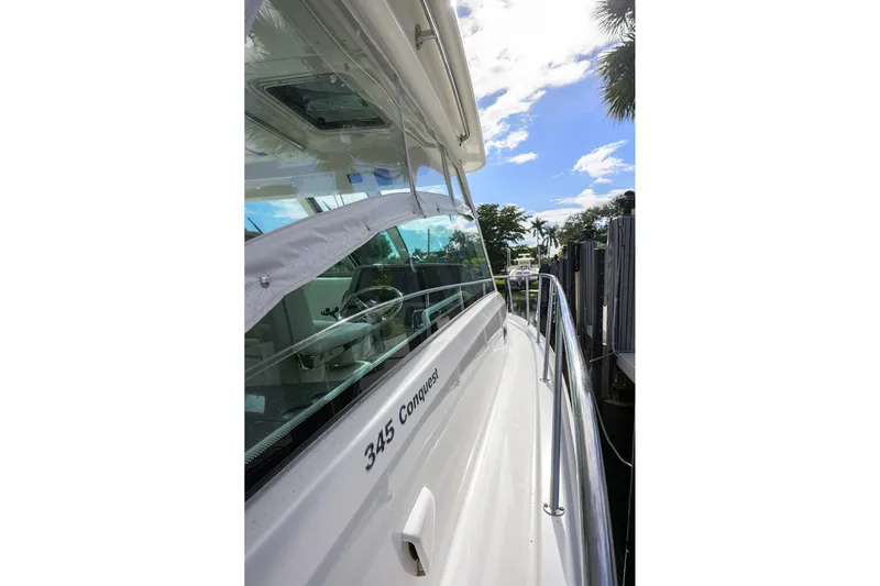 F-troop Yacht Photos Pics 2017 Boston Whaler 345 Conquest boat docked under a sunny sky.