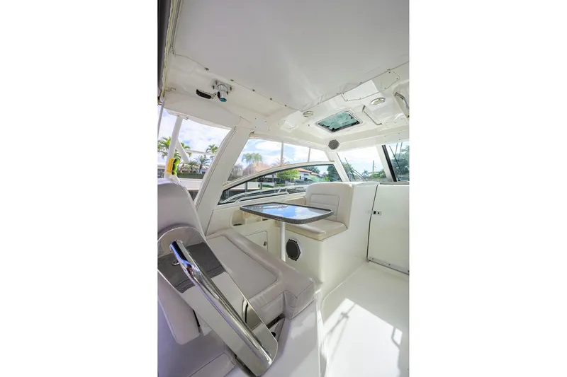F-troop Yacht Photos Pics 2017 Boston Whaler 345 Conquest interior with seating and table, showcasing luxury design.