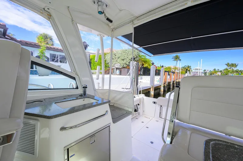 F-troop Yacht Photos Pics Interior view of a 2017 Boston Whaler 345 Conquest boat docked by a sunny marina.