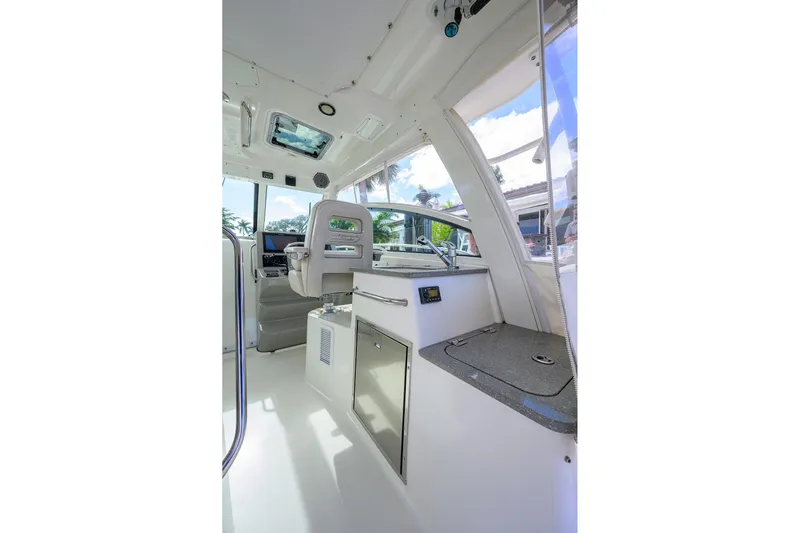F-troop Yacht Photos Pics 2017 Boston Whaler 345 Conquest interior with helm and kitchenette, featuring modern design.