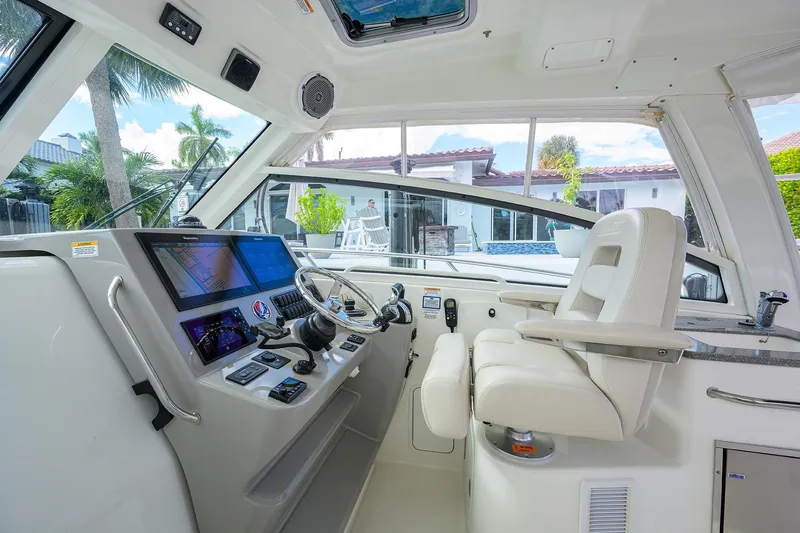 F-troop Yacht Photos Pics 2017 Boston Whaler 345 Conquest helm with modern controls and luxurious seating.