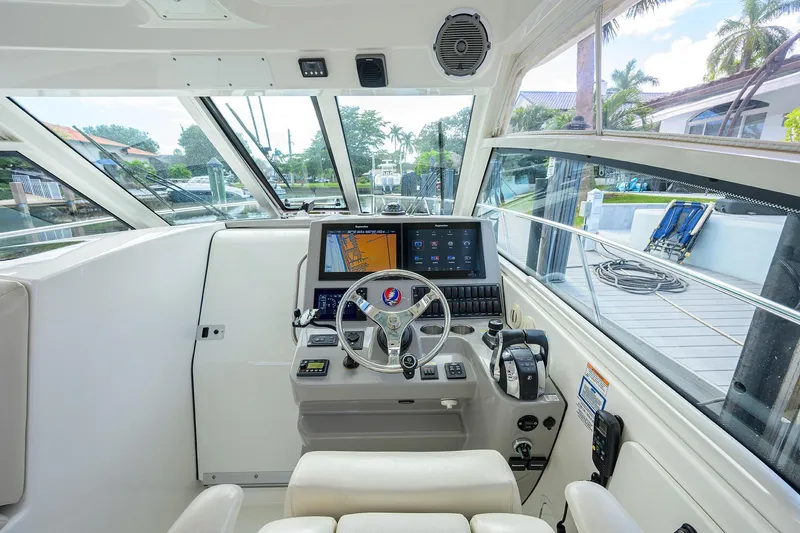 F-troop Yacht Photos Pics 2017 Boston Whaler 345 Conquest helm with advanced navigation system and luxurious seating.