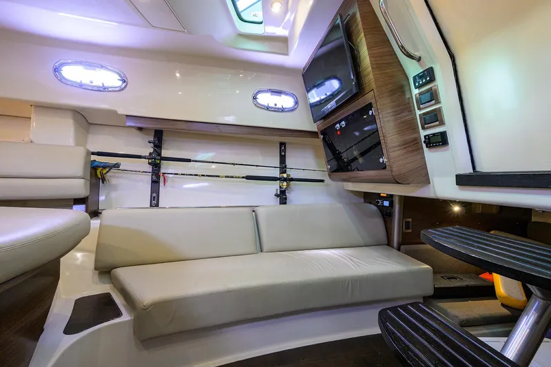 F-troop Yacht Photos Pics Interior of 2017 Boston Whaler 345 Conquest with seating, fishing rods, and entertainment system.
