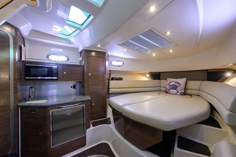 F-troop Yacht Photos Pics Luxurious interior of 2017 Boston Whaler 345 Conquest with kitchenette and seating area.