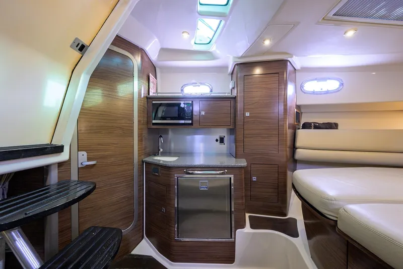 F-troop Yacht Photos Pics Luxurious interior of 2017 Boston Whaler 345 Conquest with kitchenette and seating area.