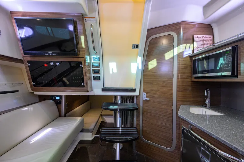 F-troop Yacht Photos Pics 2017 Boston Whaler 345 Conquest interior with TV, seating, kitchenette, and modern amenities.