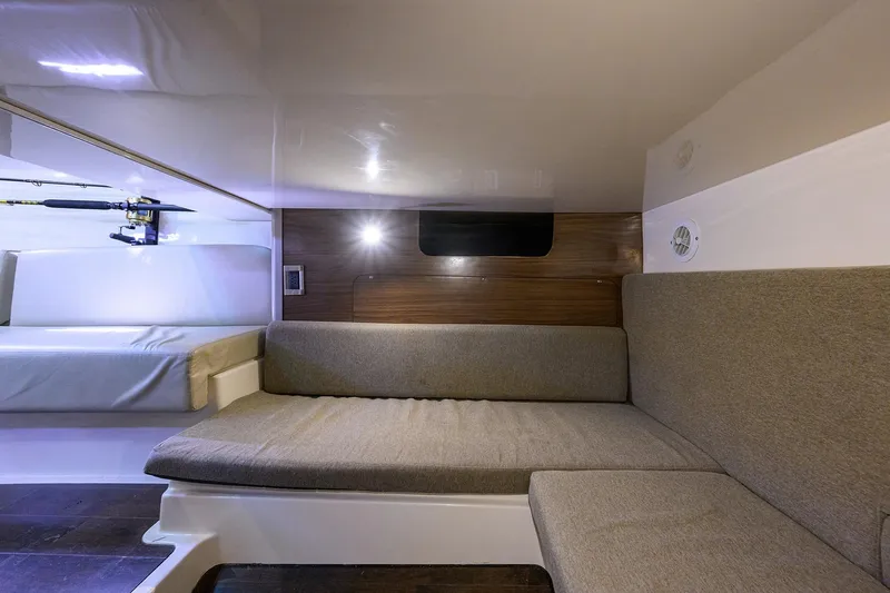 F-troop Yacht Photos Pics 2017 Boston Whaler 345 Conquest cabin interior with cozy seating and fishing rod storage.