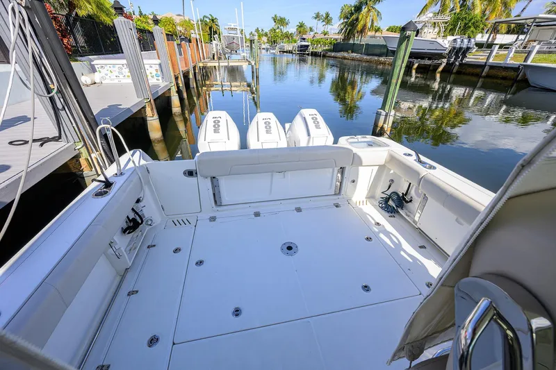 F-troop Yacht Photos Pics 2017 Boston Whaler 345 Conquest boat docked, featuring spacious deck and triple engines.