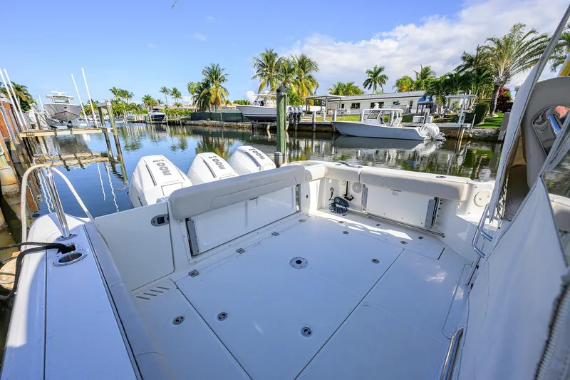 F-troop Yacht Photos Pics 2017 Boston Whaler 345 Conquest boat docked in a scenic marina with palm trees.