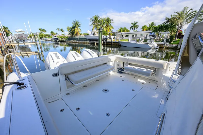 F-troop Yacht Photos Pics 2017 Boston Whaler 345 Conquest boat docked in a scenic marina setting.