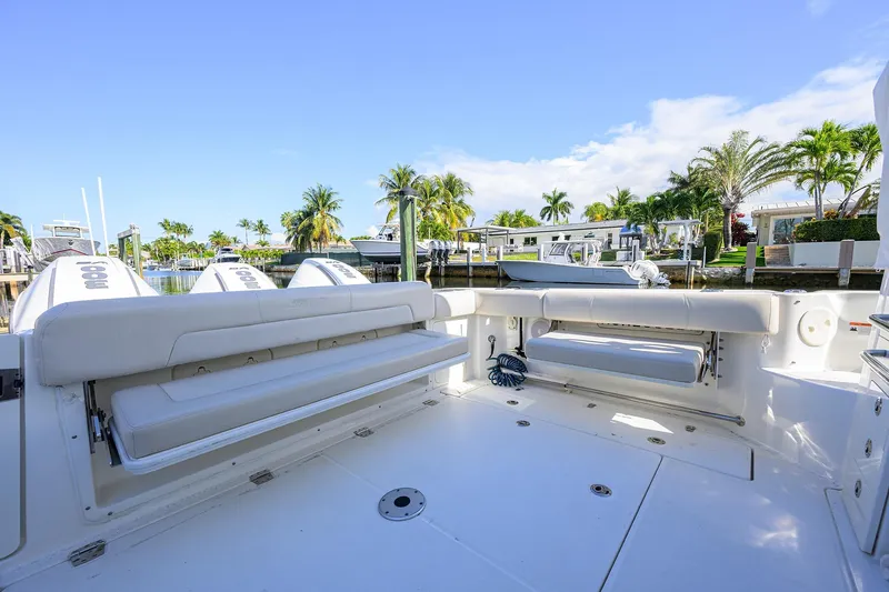 F-troop Yacht Photos Pics 2017 Boston Whaler 345 Conquest boat interior with seating, docked near palm trees.