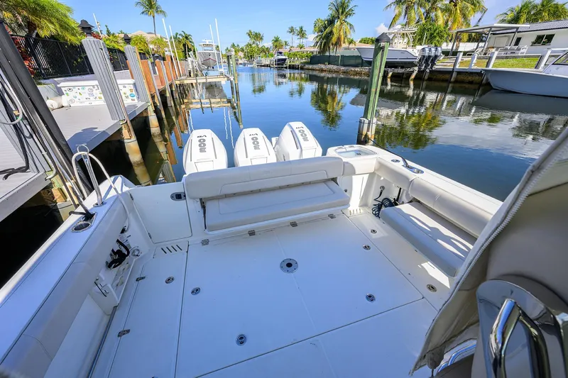 F-troop Yacht Photos Pics 2017 Boston Whaler 345 Conquest boat docked in a scenic canal setting.
