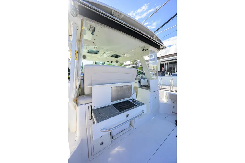 F-troop Yacht Photos Pics 2017 Boston Whaler 345 Conquest cockpit with grill and storage, showcasing luxury marine design.