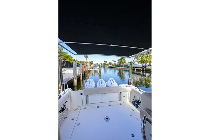 F-troop Yacht Photos Pics 2017 Boston Whaler 345 Conquest boat docked, featuring triple engines and spacious deck.