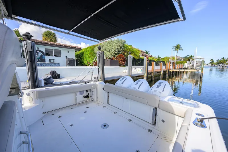 F-troop Yacht Photos Pics 2017 Boston Whaler 345 Conquest docked, showcasing spacious deck and triple outboard engines.