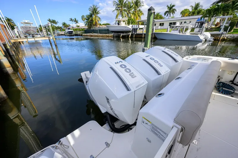 F-troop Yacht Photos Pics 2017 Boston Whaler 345 Conquest with triple Mercury outboard engines docked in a marina.