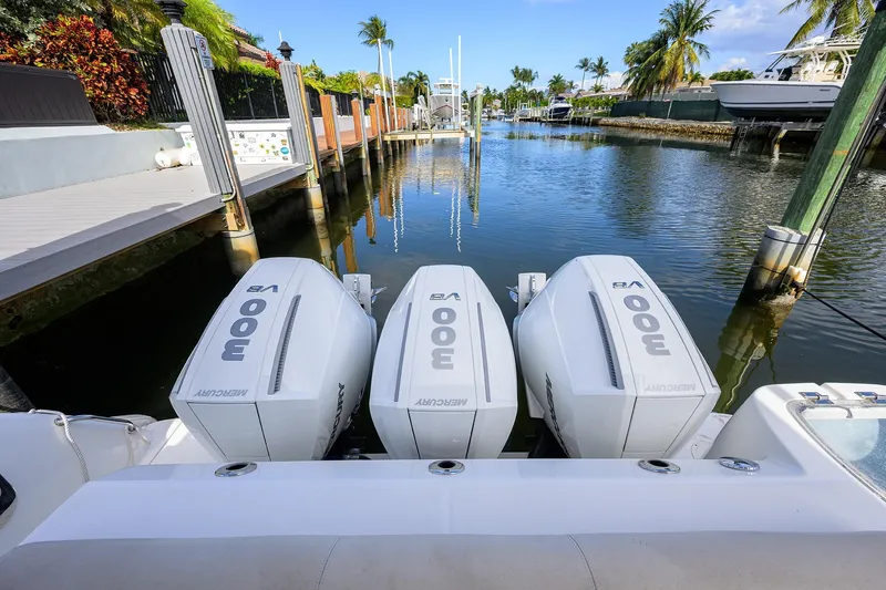 F-troop Yacht Photos Pics 2017 Boston Whaler 345 Conquest with triple Mercury 300 engines docked in a scenic canal.