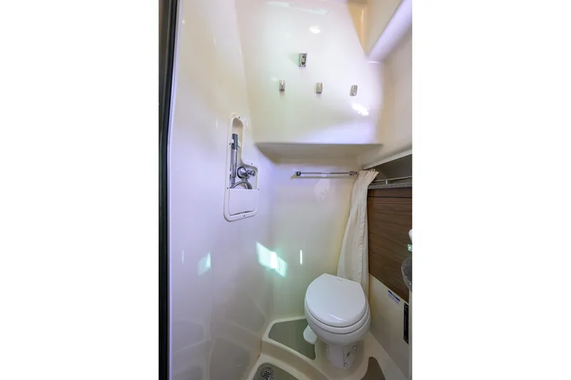 F-troop Yacht Photos Pics Compact bathroom in 2017 Boston Whaler 345 Conquest boat, featuring toilet and shower.