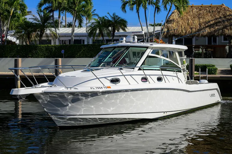 F-troop Yacht Photos Pics 2017 Boston Whaler 345 Conquest boat docked near tropical waterfront.