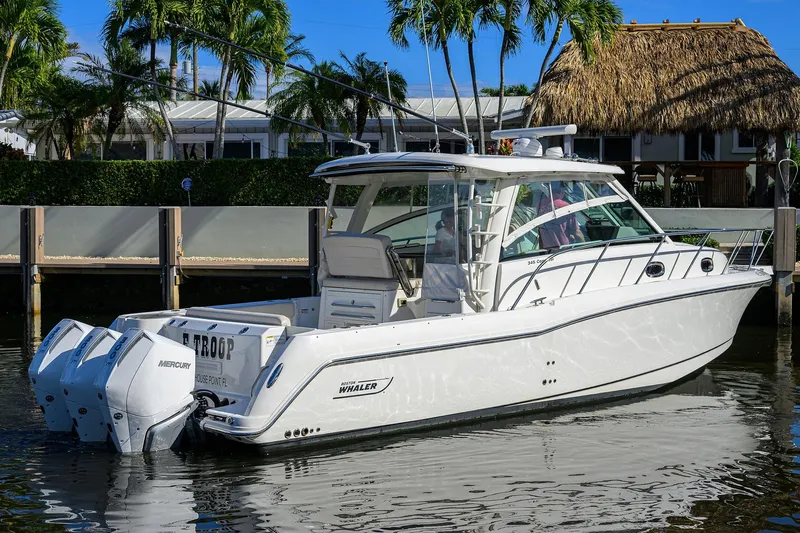 F-troop Yacht Photos Pics 2017 Boston Whaler 345 Conquest boat docked, featuring twin Mercury engines.