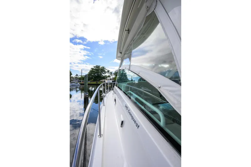 F-troop Yacht Photos Pics 2017 Boston Whaler 345 Conquest boat docked, showcasing sleek design and reflective windows.