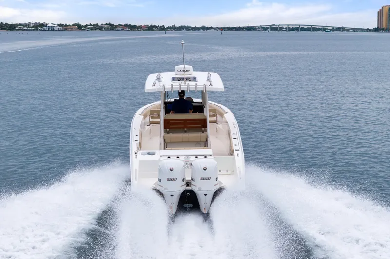 Little Perspective Yacht Photos Pics 2019 Pursuit S 288 Sport boat cruising on open water, rear view.