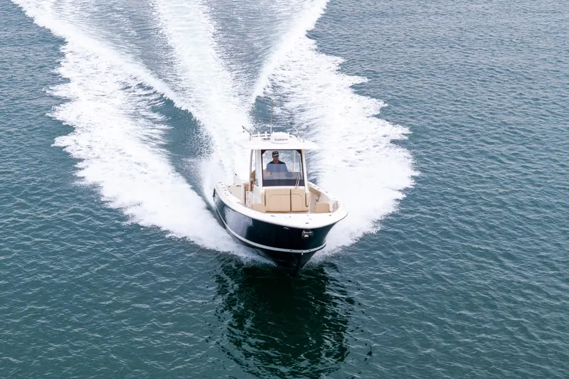 Little Perspective Yacht Photos Pics 2019 Pursuit S 288 Sport boat cruising on open water, creating a wake.