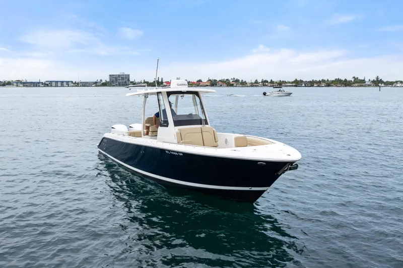 Little Perspective Yacht Photos Pics 2019 Pursuit S 288 Sport boat on calm water, clear sky background.