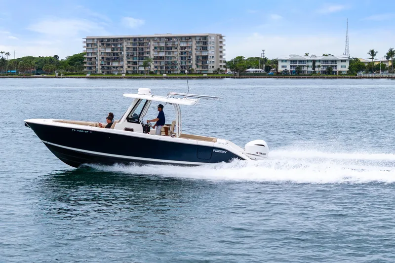 Little Perspective Yacht Photos Pics 2019 Pursuit S 288 Sport boat cruising on water near coastal buildings.