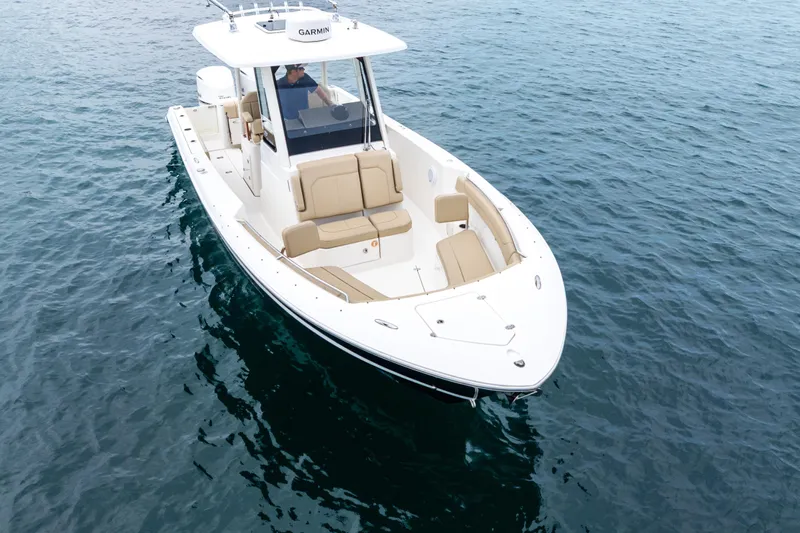 Little Perspective Yacht Photos Pics 2019 Pursuit S 288 Sport boat on calm blue water, featuring sleek design and comfortable seating.