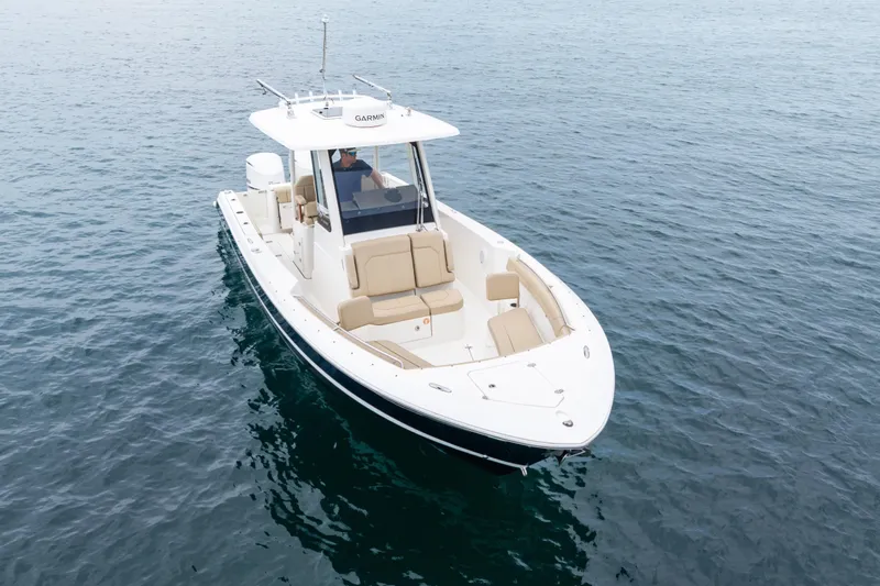 Little Perspective Yacht Photos Pics 2019 Pursuit S 288 Sport boat on calm water, featuring sleek design and spacious seating.