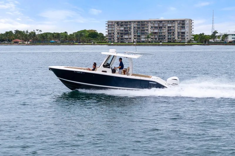 Little Perspective Yacht Photos Pics 2019 Pursuit S 288 Sport boat cruising on water near coastal buildings.