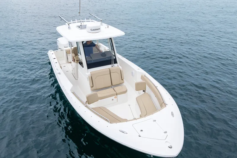 Little Perspective Yacht Photos Pics 2019 Pursuit S 288 Sport boat on calm water, featuring sleek design and spacious seating.