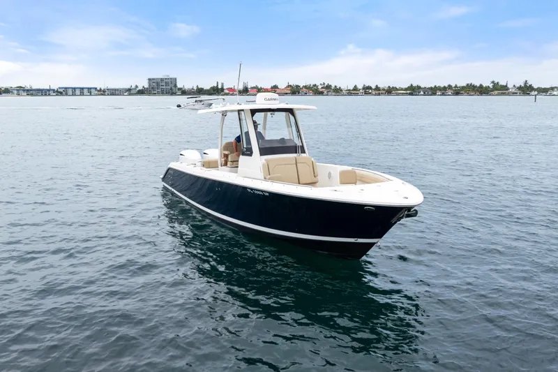 Little Perspective Yacht Photos Pics 2019 Pursuit S 288 Sport boat on calm water, clear sky background.