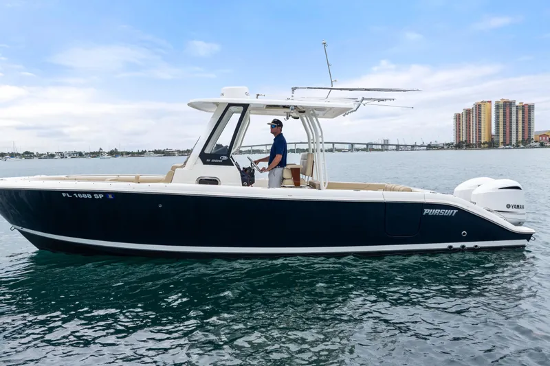 Little Perspective Yacht Photos Pics 2019 Pursuit S 288 Sport boat on water, side view with cityscape background.
