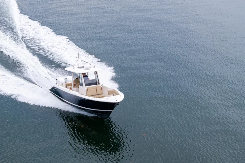 Little Perspective Yacht Photos Pics 2019 Pursuit S 288 Sport boat cruising on open water, creating a wake.