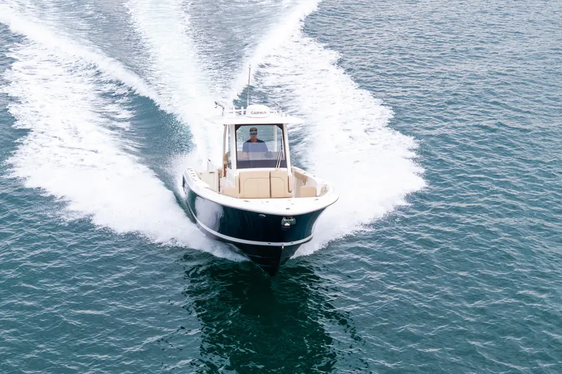 Little Perspective Yacht Photos Pics 2019 Pursuit S 288 Sport boat cruising on open water, creating a wake.