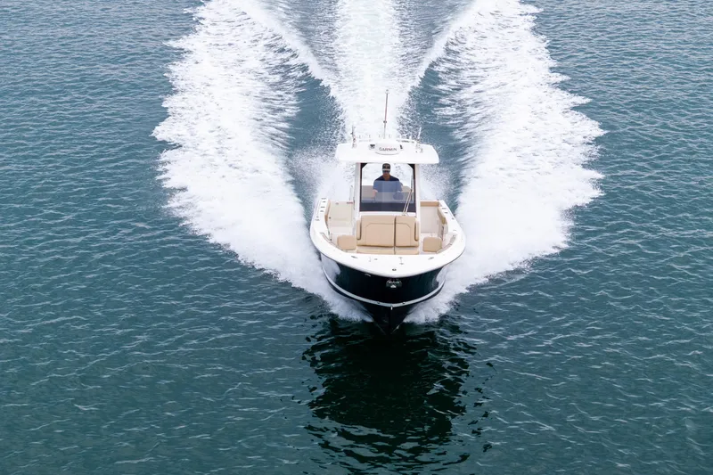 Little Perspective Yacht Photos Pics 2019 Pursuit S 288 Sport boat cruising on open water, creating a dynamic wake.