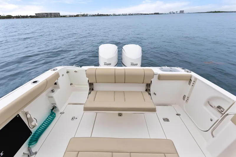 Little Perspective Yacht Photos Pics 2019 Pursuit S 288 Sport boat interior with seating and twin engines on open water.