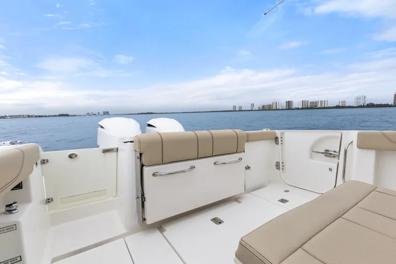 Little Perspective Yacht Photos Pics 2019 Pursuit S 288 Sport boat interior with ocean view and city skyline.