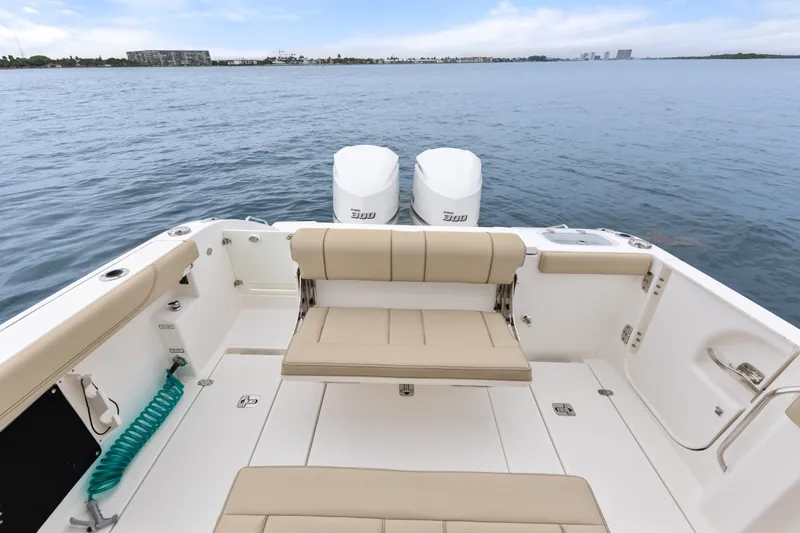 Little Perspective Yacht Photos Pics 2019 Pursuit S 288 Sport boat with dual engines on calm water.