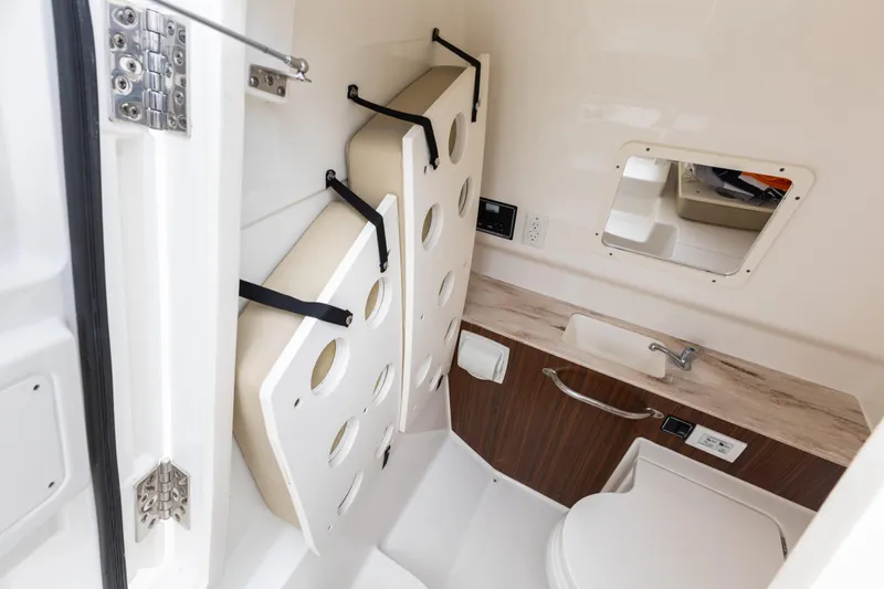 Little Perspective Yacht Photos Pics 2019 Pursuit S 288 Sport boat interior with compact bathroom, sink, and storage.