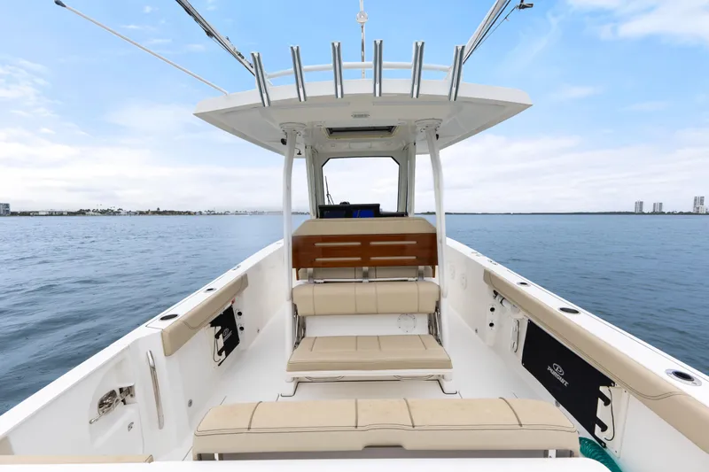 Little Perspective Yacht Photos Pics 2019 Pursuit S 288 Sport boat interior on calm water, showcasing seating and helm.