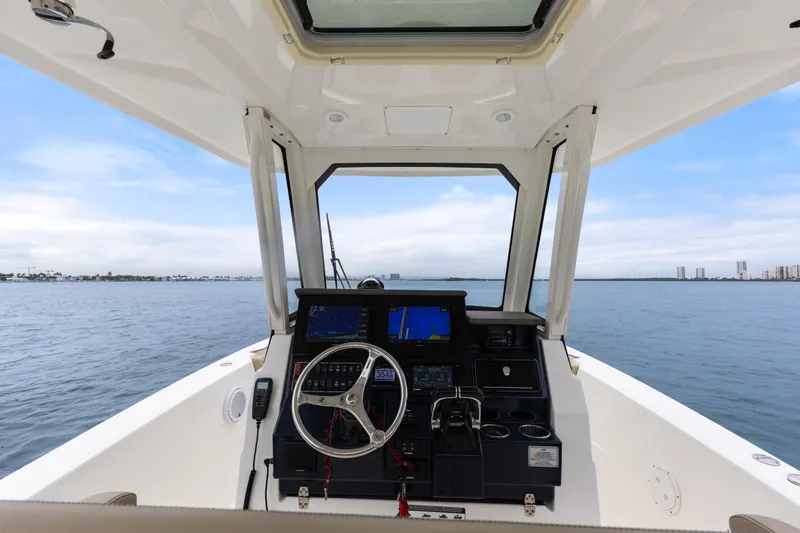Little Perspective Yacht Photos Pics 2019 Pursuit S 288 Sport boat helm with ocean view and navigation equipment.