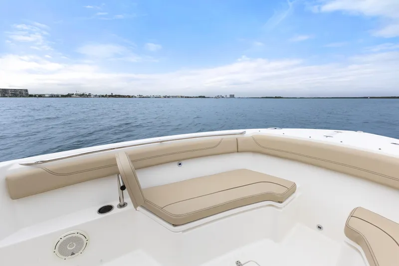 Little Perspective Yacht Photos Pics 2019 Pursuit S 288 Sport boat interior with beige seating, overlooking calm waters.