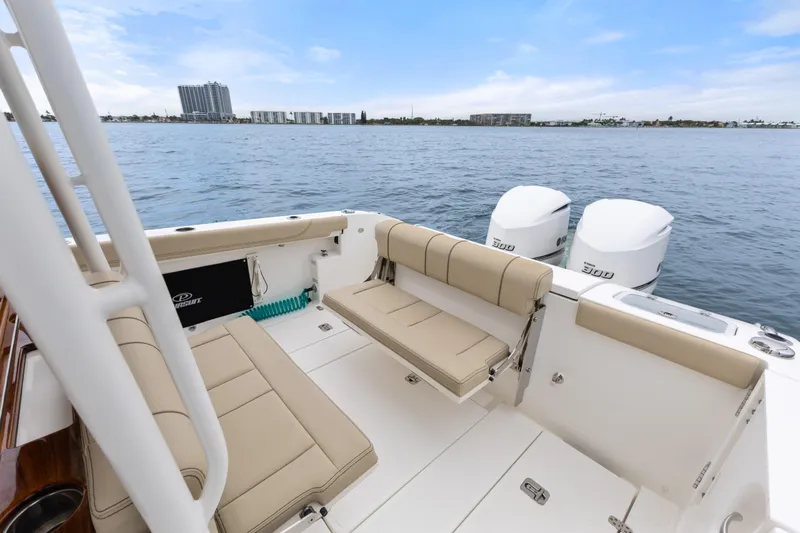 Little Perspective Yacht Photos Pics 2019 Pursuit S 288 Sport boat with beige seating and twin engines on open water.