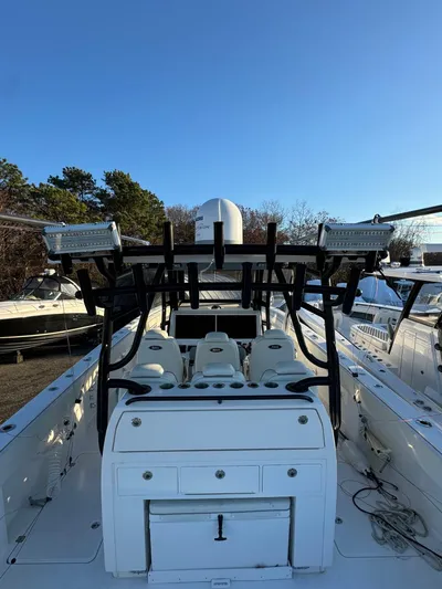  Yacht Photos Pics 2022 Invincible 40 Catamaran with seating and storage, docked under clear blue sky.